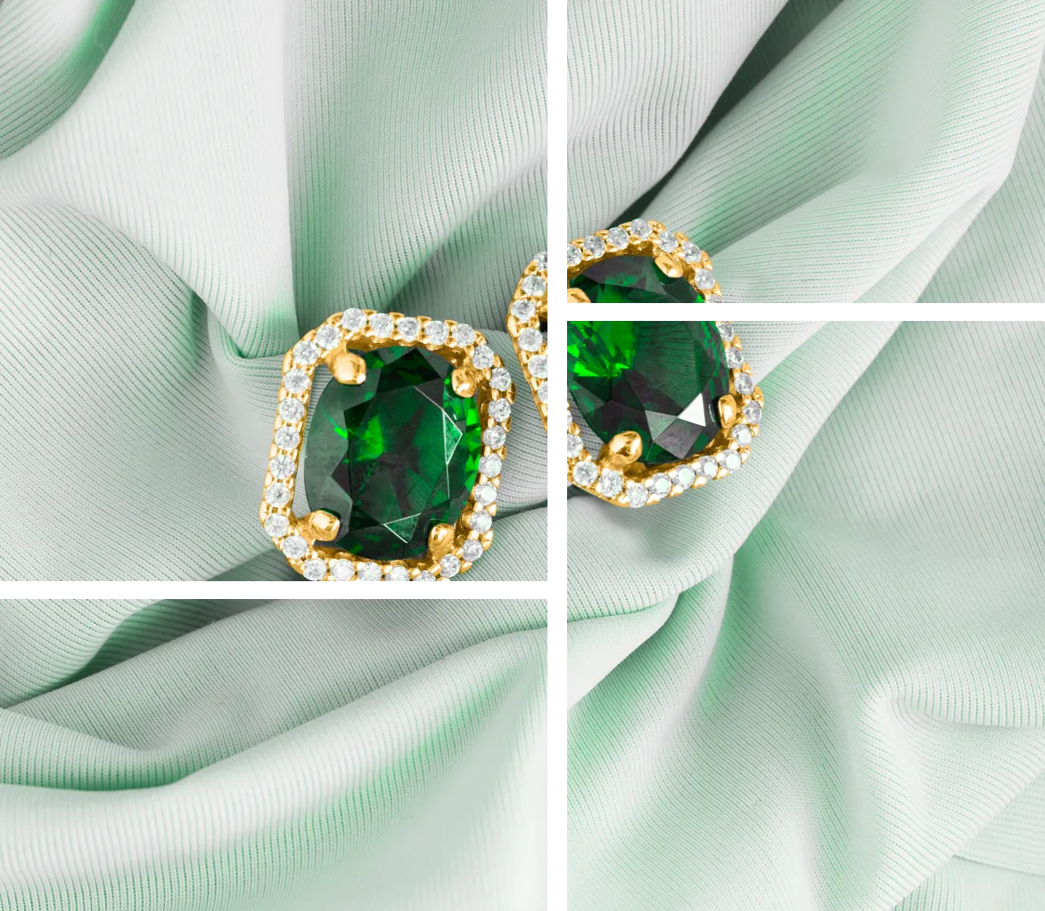 Emerald and diamond earrings on silk.