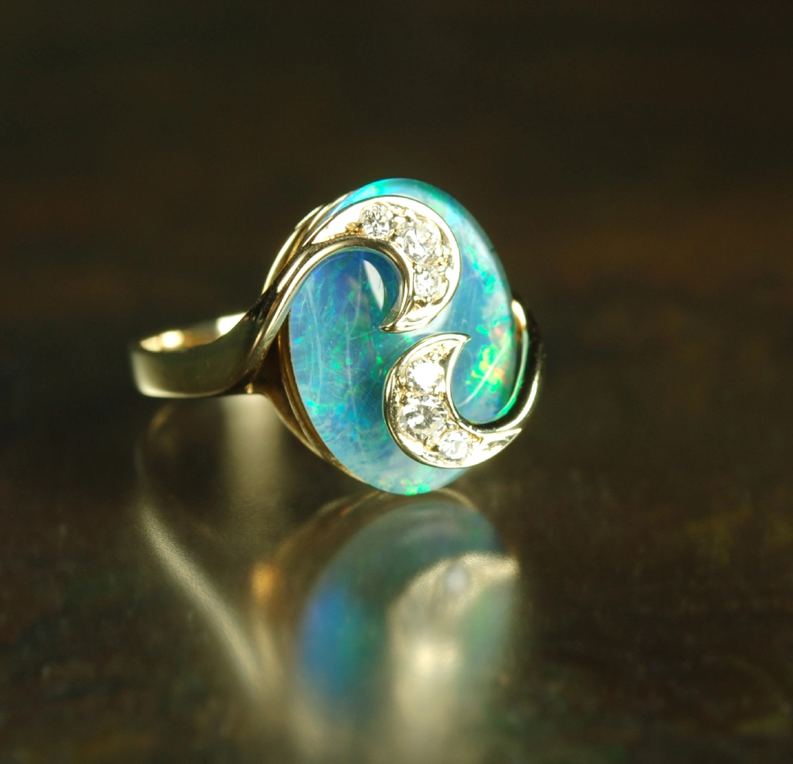 Opal and diamond ring in gold setting.