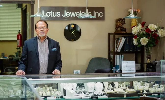 A man standing in front of a store window.