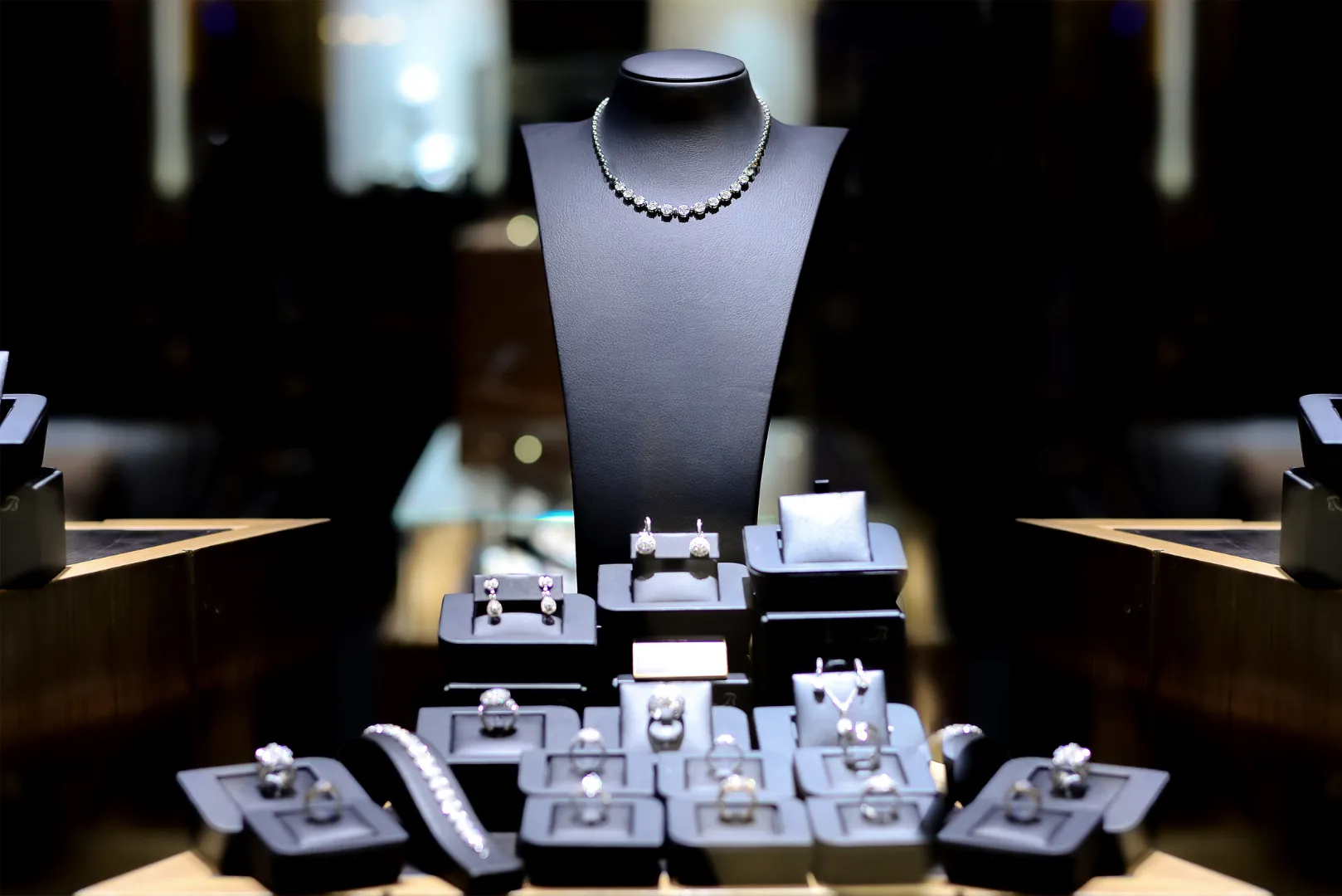 A display of jewelry in boxes on top of a table.