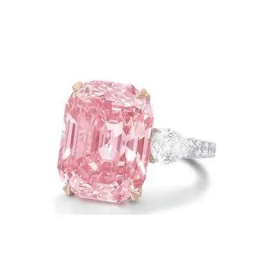 A pink diamond ring with two smaller diamonds on each side.